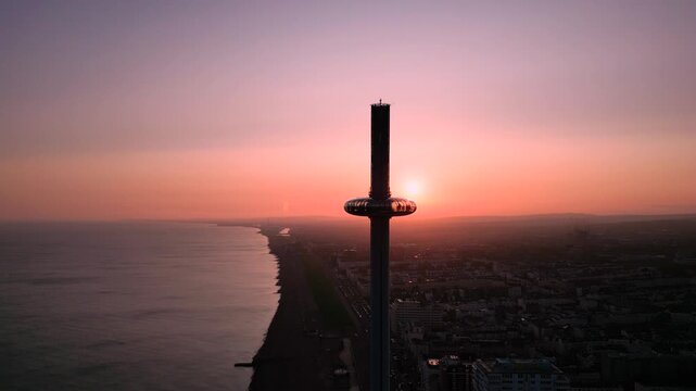 Aerial fly Sunset View of Brighton City with Sea Reflections and Brighton i360 Silhouette