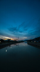 Fototapeta premium River Landscape at Dusk with Dramatic Sky