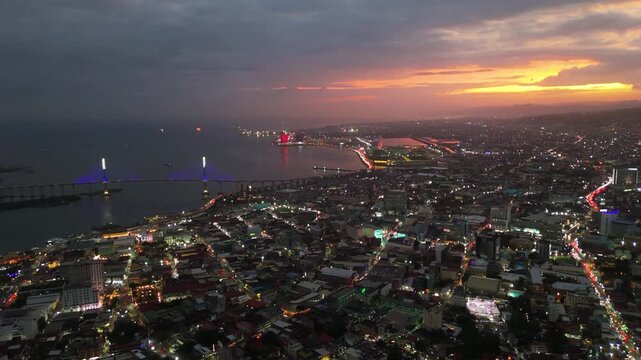Aerial skyline cityscape view at dusk sunset with city of Cebu illuminated, Philippines