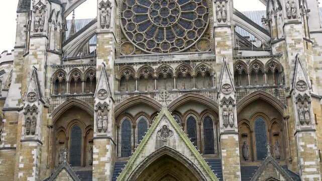 Notre Dame Cathedral in Paris showing the facade with rose window and gothic architectural details. Daytime view of historic church exterior