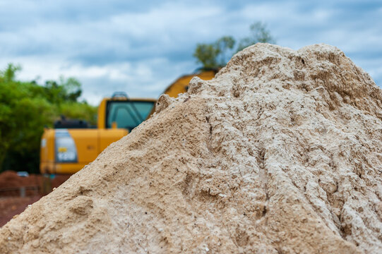 Construction site close-up earthwork pile and heavy machinery in outdoor environment