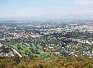 Obraz premium Skyline of Universal City as seen from the top of Cahuenga Peak at Wisdom Tree during a summer season in Los Angeles, California, USA