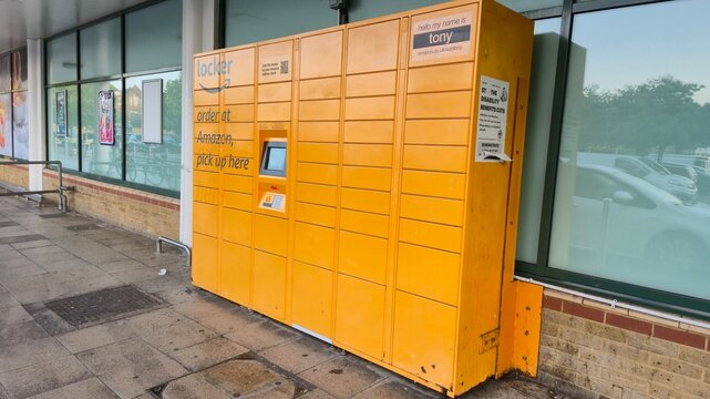 London UK - 07.01.2025 Amazon parcel locker outside retail building with bright yellow self service pickup station for online orders and convenient contactless delivery collection