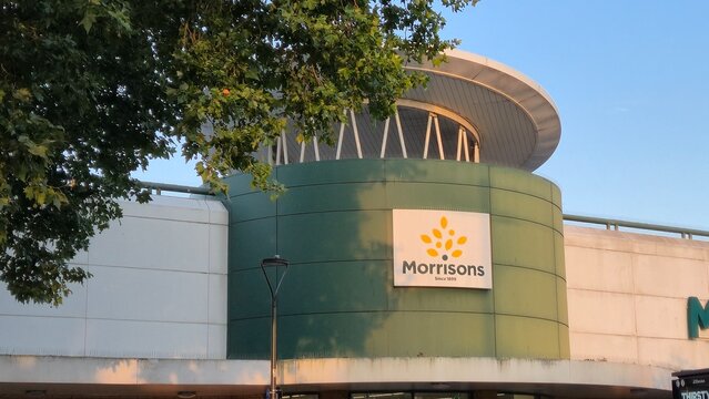 London UK - 07.01.2025 morrisons supermarket exterior with brand logo on modern retail building facade surrounded by urban environment in warm evening sunlight