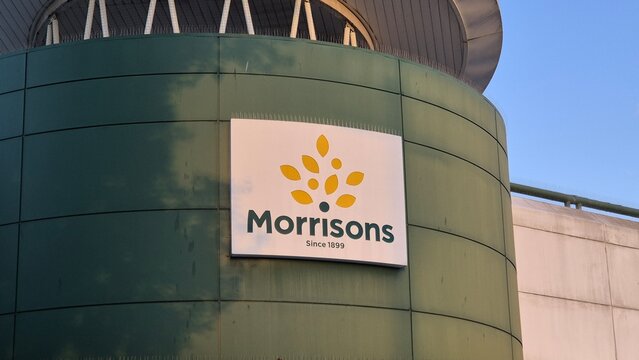 London UK - 07.01.2025 morrisons logo on curved retail building facade close up view of supermarket branding in modern urban environment with evening sunlight