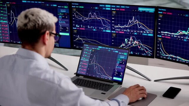 Stock Broker Watches Multiple Trading Screens While Working
