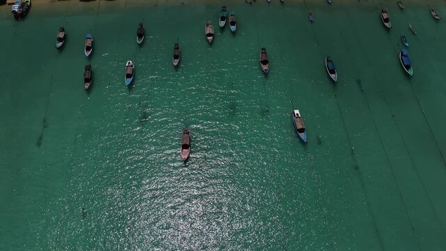 Aerial view of Ko Surin Marine National Park. Traditional long-tail boats and houses of Moken tribe Village or Sea Gypsies and tropical waters of Surin Islands in Thailand, Phang Nga.
