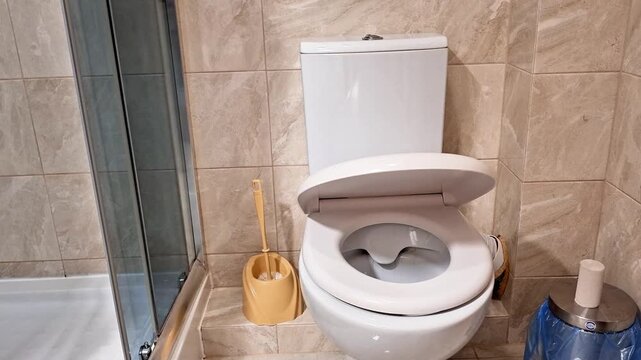 Soft closing toilet seat demonstration in a modern bathroom, highlighting smooth lid movement, quiet closure, and practical everyday convenience for hygiene and comfort