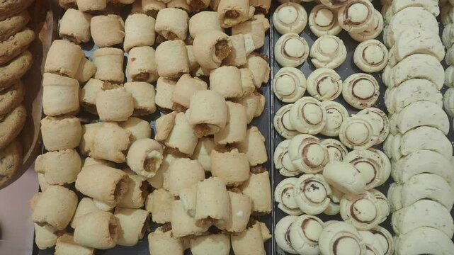 Close up moving shot of rows of delicious cookies baked and ready for sale