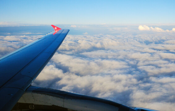 Edelweiss Airbus A320 wing and clouds at sunset