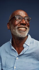 Fototapeta premium Older Man with Beard, Glasses, Smiling at Camera.