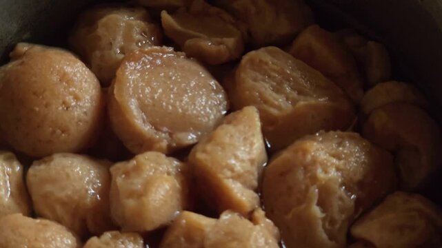 Soya chunks, also known as soybean protein or meal maker, being soaked in a pot of water to soften. High protein meat substitute or vegetarian ingredient used in Indian cooking and healthy diets.