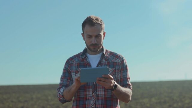 Farmer reviews crop data confidently, Farmer rigorously analyzes soil quality and crop growth data with confidence