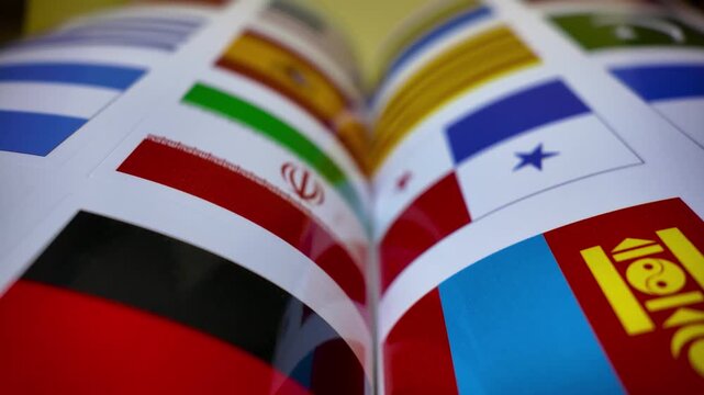Open pages featuring flags from various nations around the globe