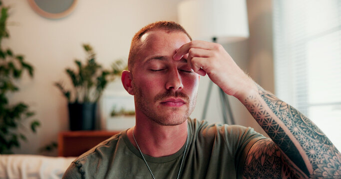Relax, eft and balance with man on sofa in home for ptsd treatment, mental health and chakra. Pressure point, trauma release and zen with person tapping in living room of house for holistic treatment