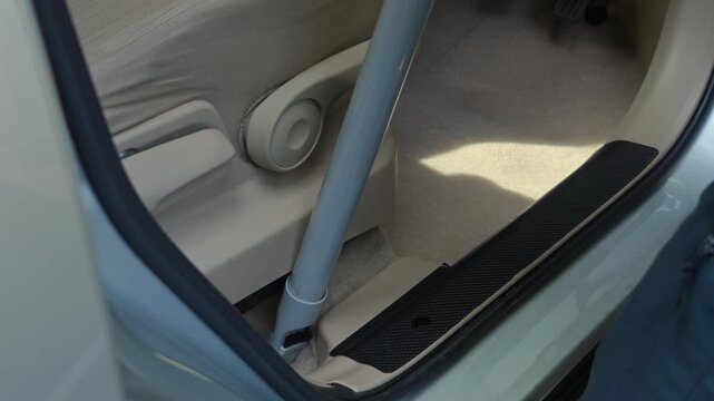 People using vacuum cleaner to clean mpv car interior, warn morning light, natural background