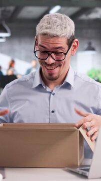 Manager Happily Opening A Gift Package Received