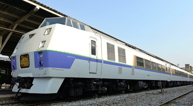 A refurbished srt kiha 183 series express train in a purple and white livery stands on the tracks at Hua Lamphong station in Thai capital Bangkok
