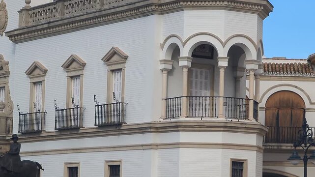 Historic building in Sevilla City. Ornate architecture stands out. A majestic statue on horseback captures attention. Explore the rich culture and heritage here.
