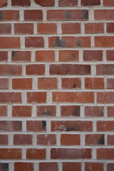 Fototapeta premium Red brick wall background, with old and rough surface, vertical format, no person