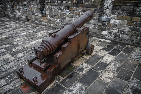 Ancient fortifications are displayed on a brick and stone platform.