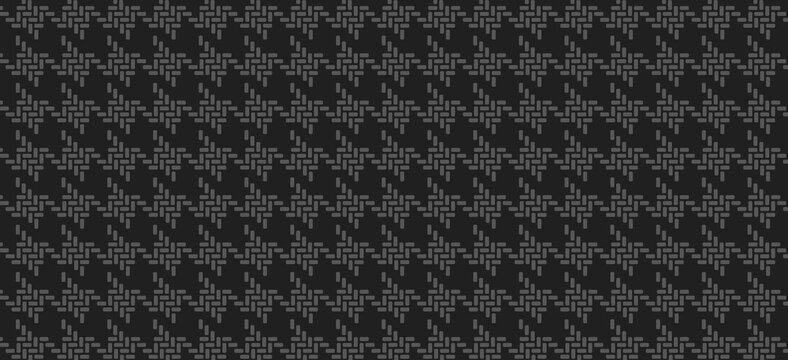 Dark charcoal grey houndstooth pattern background with classic repeating textile texture for sophisticated fashion design and professional backdrop