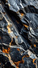 Fototapeta premium Close-up of a dark rock face with striking orange and yellow mineral veins, showcasing natural geological patterns and textures.