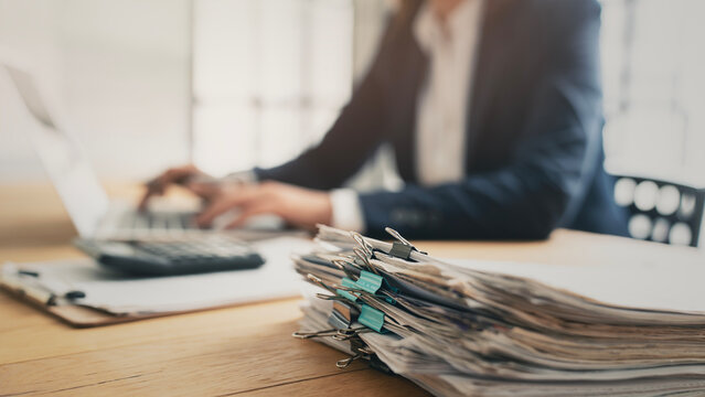 Business person working laptop and documents
