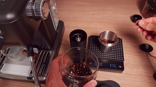 Top Down View Of Hands Weighing Coffee Beans To Exact Eighteen Grams On Digital Scale Near Espresso Machine And Manual Grinder, Precision Brewing And Barista Routine
