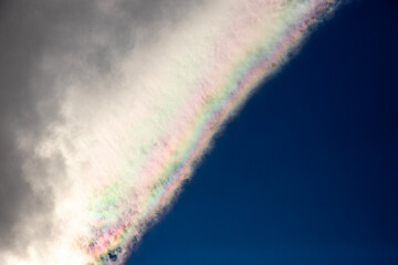 Obraz premium Rainbow in the blue sky with clouds