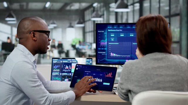 Business Analyst Reviews KPI Data Dashboard On Computer Screen