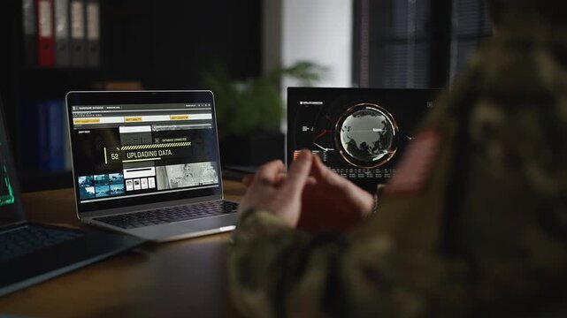 U.S. intelligence officer uploading gathered data and conducting surveillance
