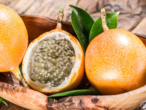 Granadilla fruits on the wooden table.