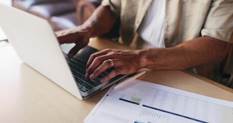 Fototapeta premium Laptop, documents and hands of man in home for finance review, budget planning and research. Remote work, typing and person on computer with paperwork, graph and statistics for financial analysis