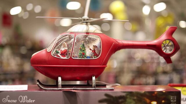 shot of christmas toy helicopter with snow inside moving particles festive winter decoration warm light cozy holiday atmosphere
