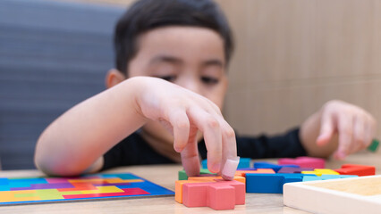Happy Child Playing with Colorful Blocks