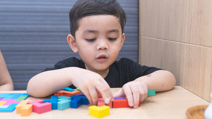 Happy Child Playing with Colorful Blocks