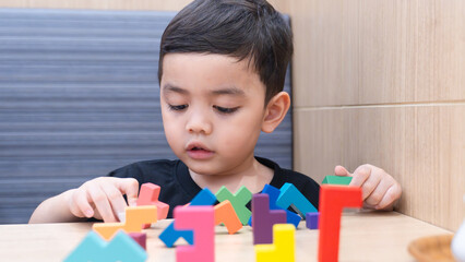 Happy Child Playing with Colorful Blocks