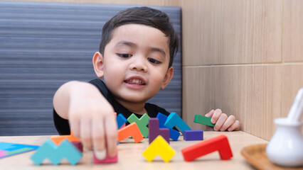 Happy Child Playing with Colorful Blocks