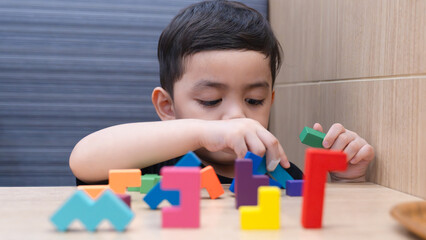 Happy Child Playing with Colorful Blocks