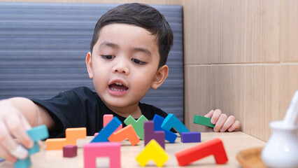 Happy Child Playing with Colorful Blocks