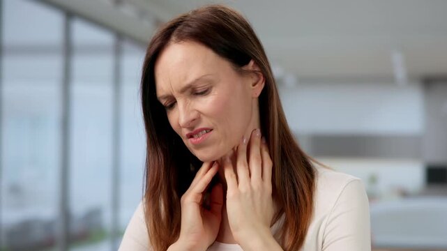 Throat And Salivary Gland Disorders. Woman Experiencing Neck Pain