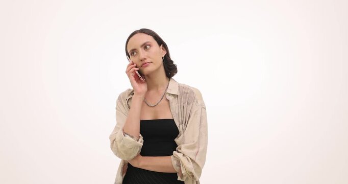 Woman calls boyfriend on smartphone waiting for reply. Female crosses arms checking screen again while call keeps ringing still without answer
