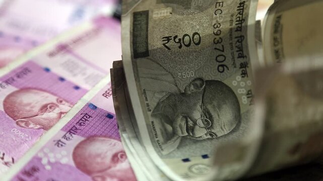 Closeup 4k video of Indian 500 rupee notes stacked and rolled. Financial concept showing cash money, savings, economy, and wealth in India.
