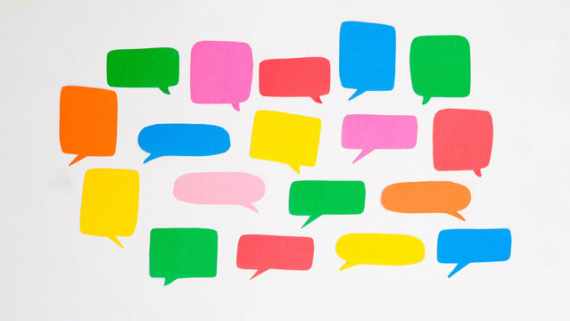Pattern of multi-colored speech bubbles on a white background. Communication and social connections concept