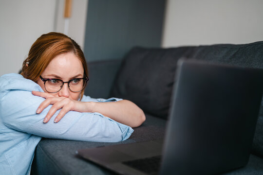 Woman experiencing burnout and stress at home with laptop