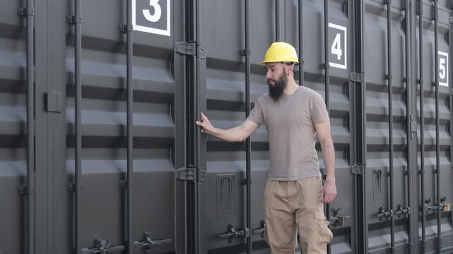 Dock worker opening shipping container door
