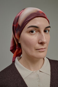 Confident oncology patient in headscarf studio portrait