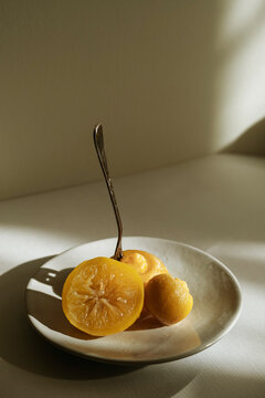 Preserved lemon slices on dish with fork in bright sunlight