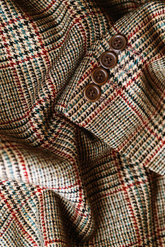Close up of glen check tweed wool fabric with buttons